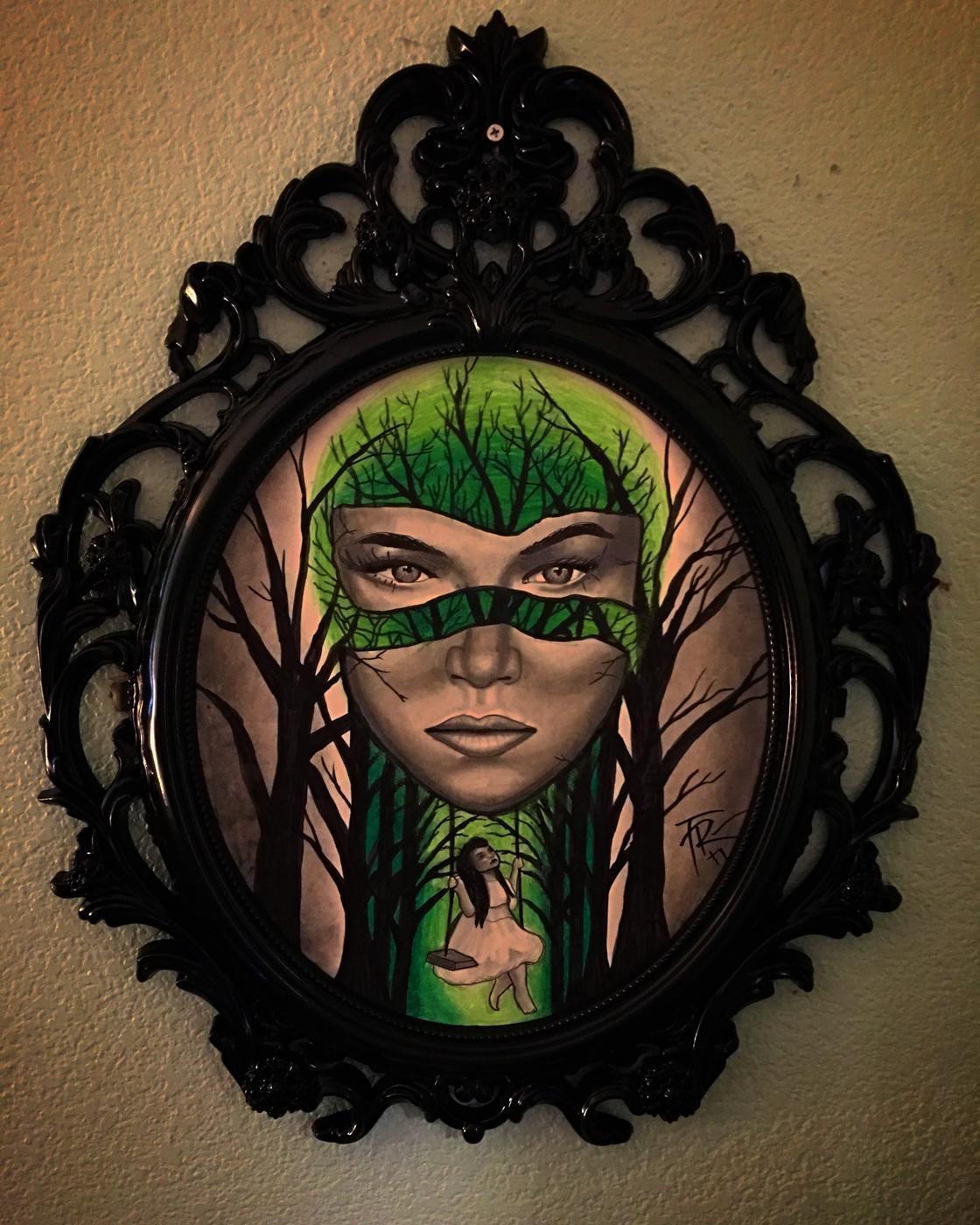 An original painting hanging in the shop in a black scrollwork frame, signed TR